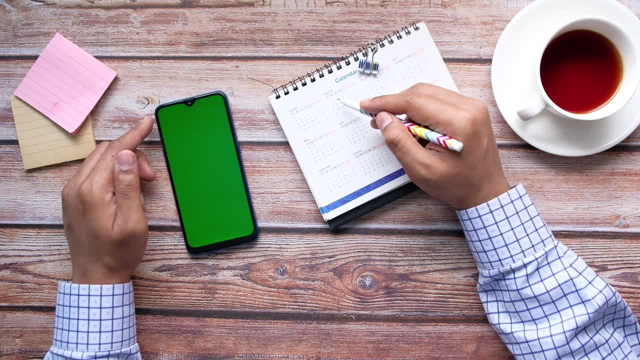 Person Planning on a Wooden Desk