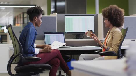 video of diverse businesswomen working on project and using laptop