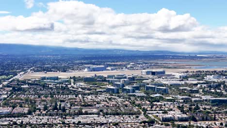 aerial view of moffett field and surrounding urban landscape in silicon valley, california, featuring iconic hangars and suburban areas