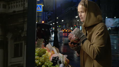 woman buying fruit in outdoor market