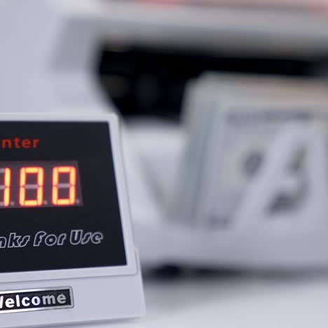 Automatic mechanism for bank financial operations. Electronic equipment shows the amount of money on the device during counting paper banknotes