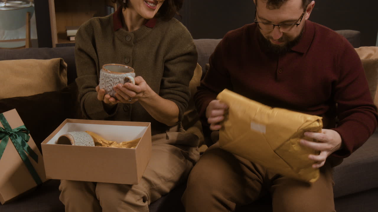 Couple opening Christmas gifts together
