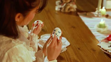 mother and child decorating easter eggs