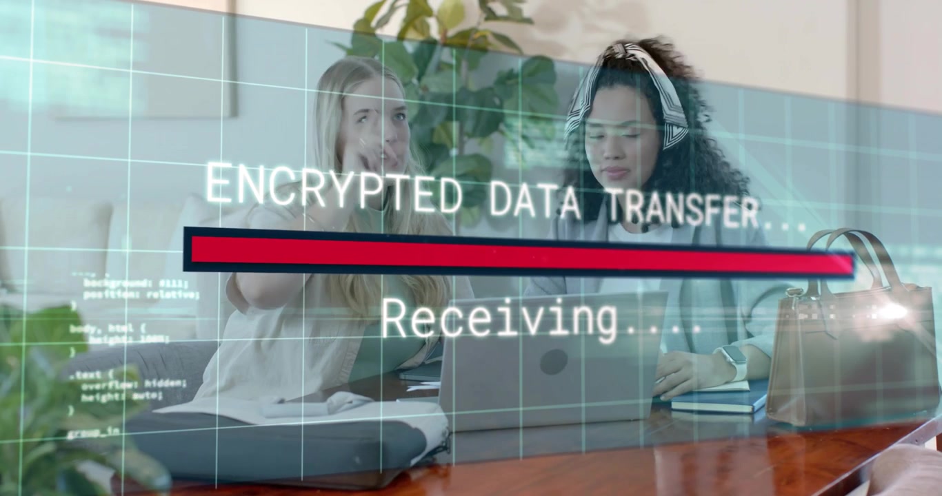 Technology colleagues typing laptop encrypted transfer overlay appearing with progress bar filling
