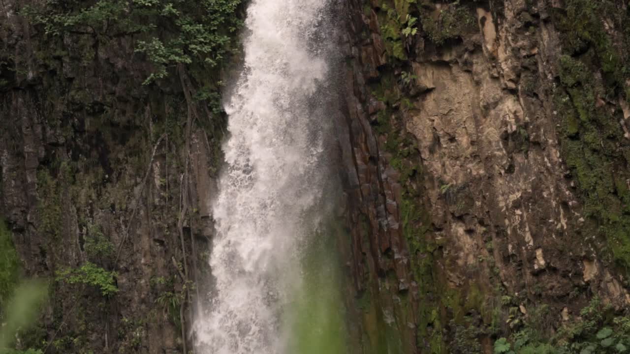 Close-up shot of the powerful stream of water section of the Catarata del Toro waterfall