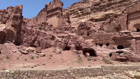 Petra-valley-in-Wadi-Musa,-Jordan-with-The-Treasury-in-the-middle-of-a-rocky-and-mountainous-landscape,-an-UNESCO-heritage-site,-ancient-Nabatean-Kingdom-4K-Establish-Shot