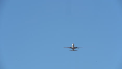 airplane flying high above through the sky toward arrival at destination