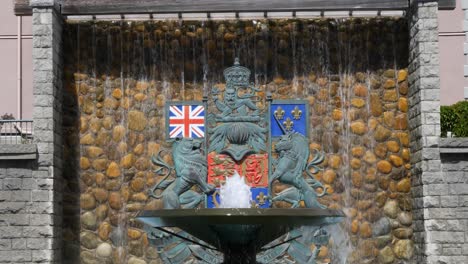 confederation fountain in victoria, canada, british columbia.canada’s coat of arms in the background.