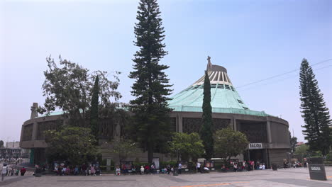 tourists at the new or modern basilica of our lady of guadalupe site in mexico city - tilt down reveal