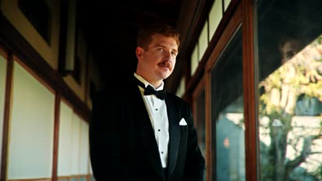 groom in tuxedo by japanese window