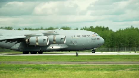 large military transport plane descends onto runway and stops after a few seconds