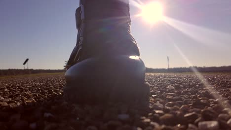 Woman-walking-,-towards-camera,-alone-on-an-empty-road-stepping-over