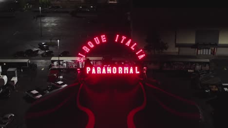 red led light sign of paranormal cirque italia at night