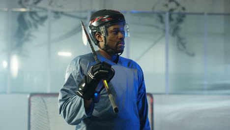 Portrait-Of-A-Happy-Male-Hockey-Player-Smiling-At-The-Camera-On-The-Ice-Arena