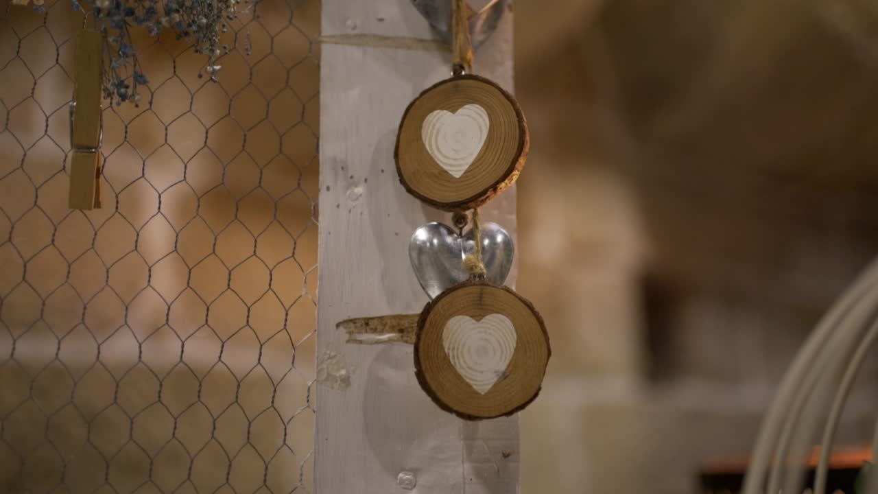 Close view of wooden heart ornaments hanging on decorative display