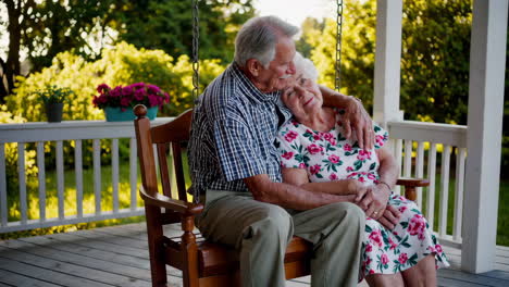 senior couple enjoying time together on a porch swing