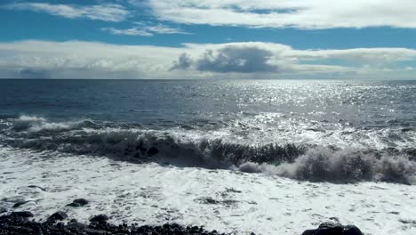 pan shot of rocks clearly visible on the surface of the beach