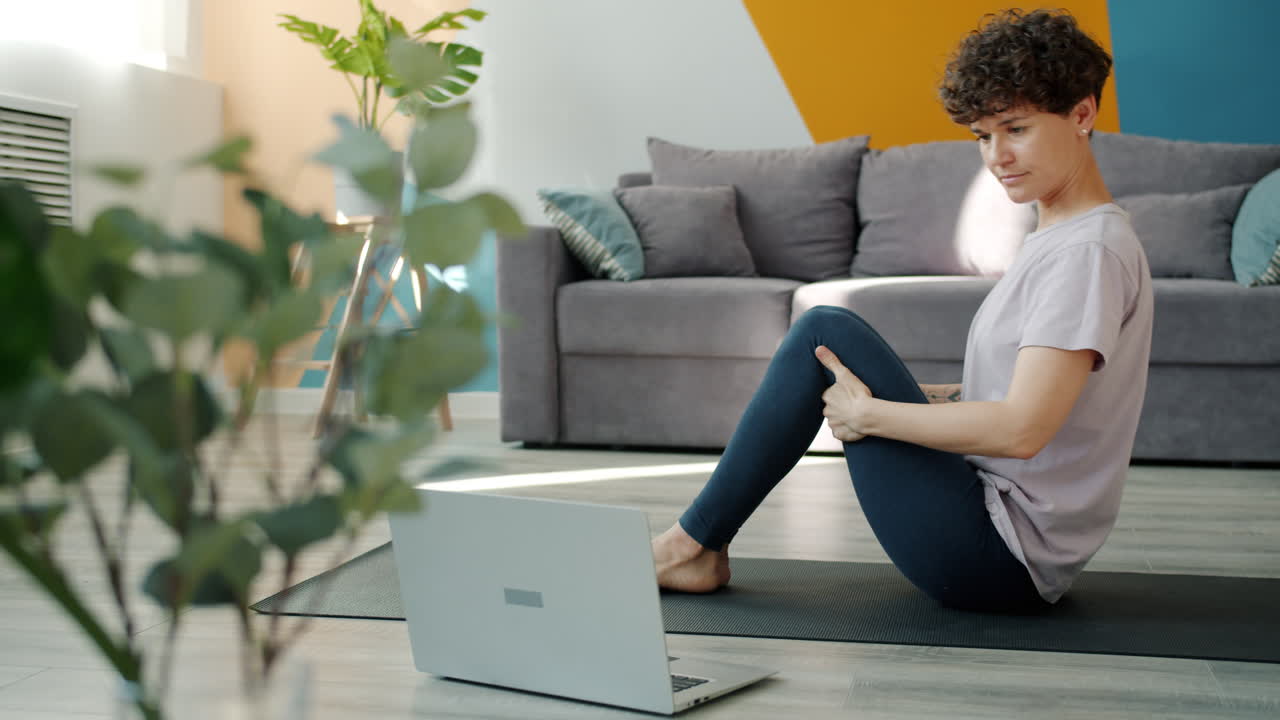 Woman doing yoga at home online