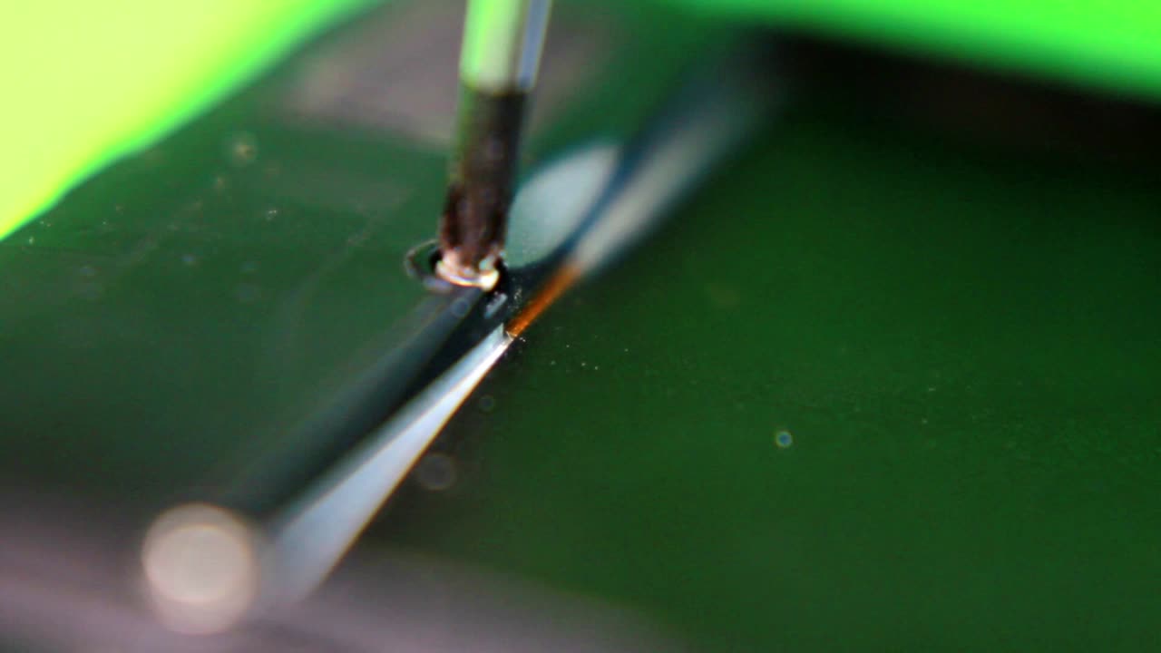 Unscrew the small screw from the smartphone using a screwdriver