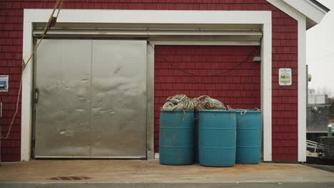 Fishing-Pier-with-blue-barrels-and-rope-line-for-lobster