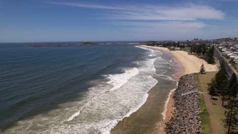 oyster bank breakwall and newcastle breakwater seen from distance at stockton beach in nsw, australia. aerial shot