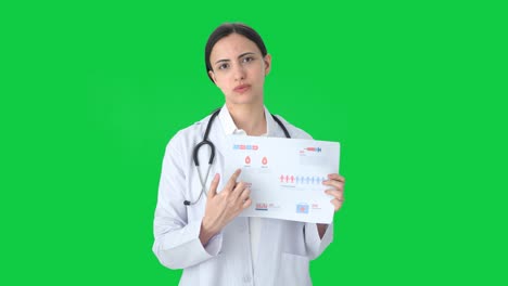 Doctora-India-Explicando-Informes-Médicos-A-La-Pantalla-Verde-Del-Paciente.