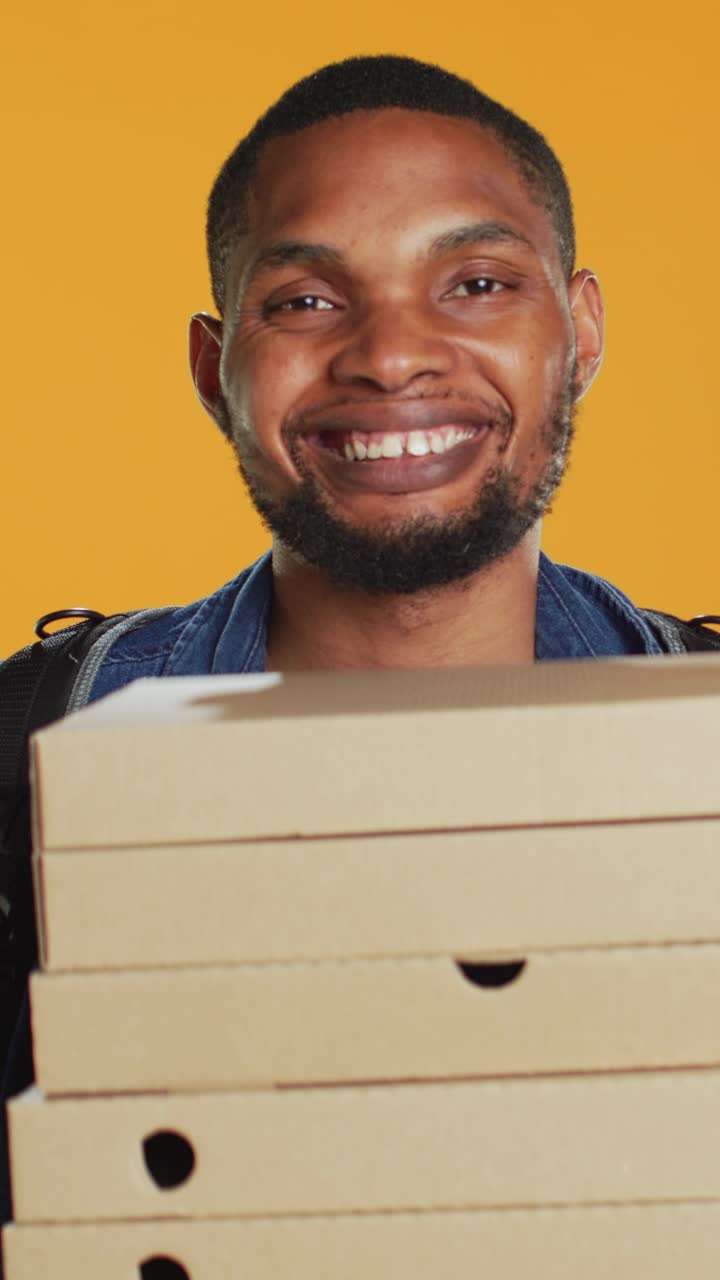 Smiling African American Delivery Man Holding Pizza Boxes