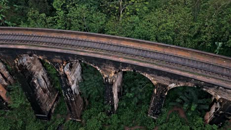 stunning aerial drone footage of the famous nine arches bridge in ella, sri lanka.