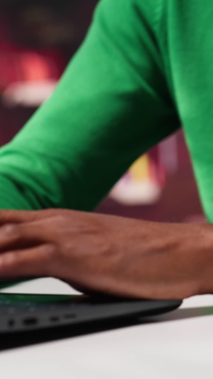 Vertical Video African american freelancer at home office sitting at desk and typing on laptop