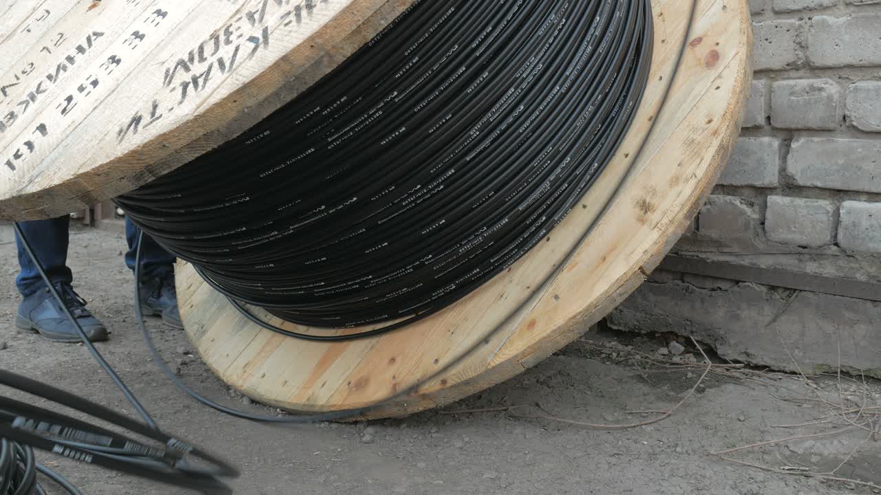 un primer plano. un cable de fibra óptica en un gran carrete de madera.