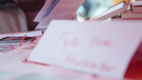 a self-written sign "flyer to take away" stands on a bar table