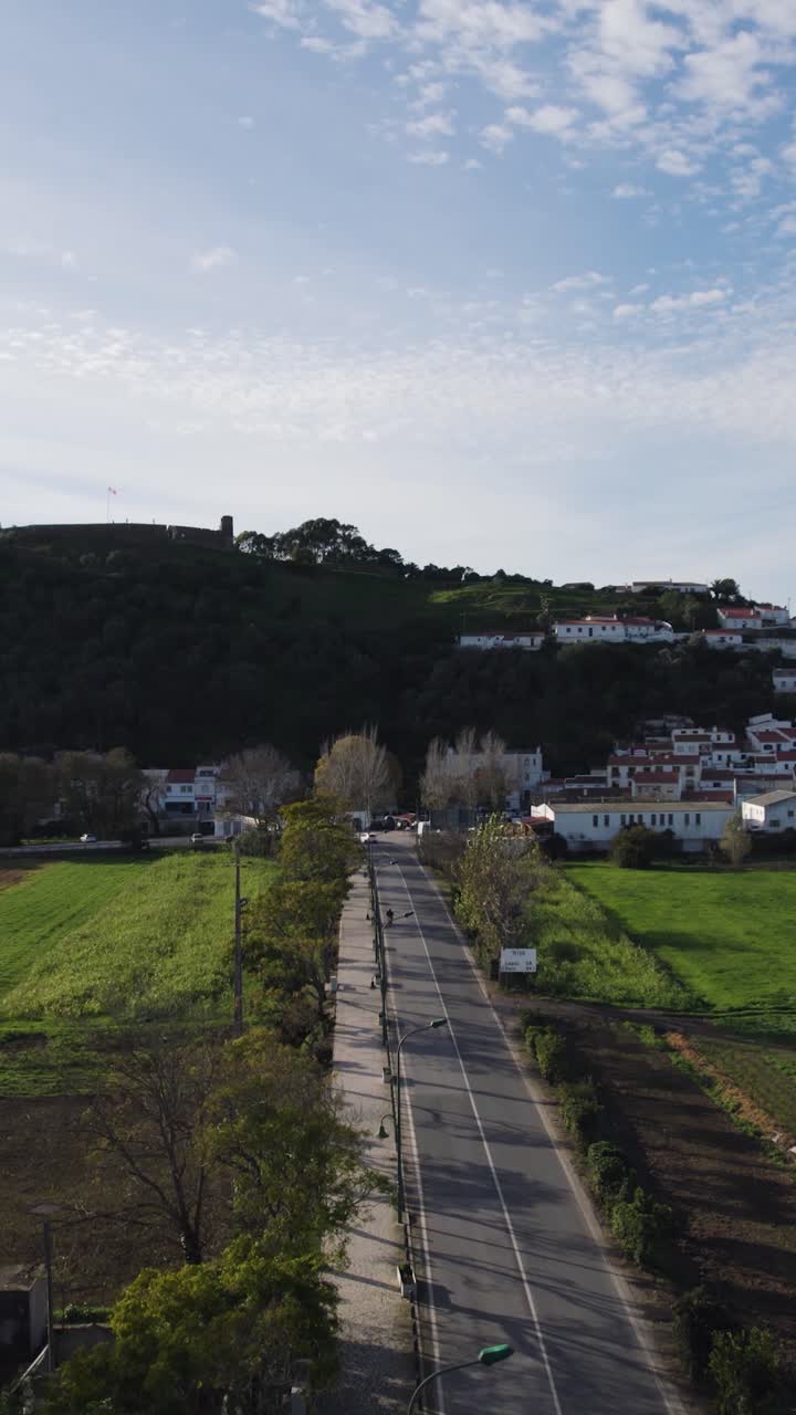 Vertical aerial fly-over of a road leading to the village of Aljezur in Portugal