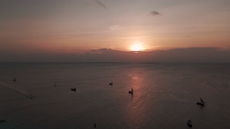 traditional dhows for sunset cruise in nungwi, zanzibar, tanzania. aerial drone shot