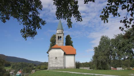 old church in slovenia countryside on sunny summer day wide left pan