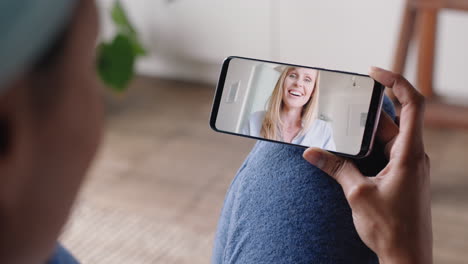 young-woman-having-video-chat-using-smartphone-at-home-chatting-to-friend-enjoying-conversation-sharing-lifestyle-on-mobile-phone