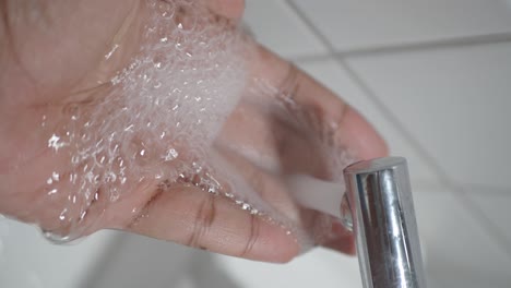 washing hands under a tap