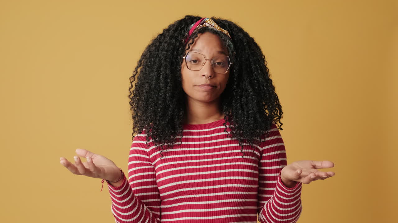 Young Woman Thinking and Shrugging with Uncertainty