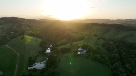 Drone-shot-of-hilly-terrain-in-Cooroy-Noosa,-with-the-Glass-House-Mountains-in-background