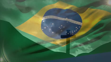 Animation-Des-Schwenkens-Der-Brasilianischen-Flagge-über-Der-Silhouette-Eines-Kreuzes-Auf-Einem-Berg-Vor-Wolken-Am-Himmel