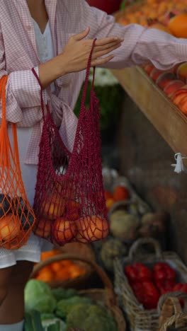 woman shopping for fruit at a local market