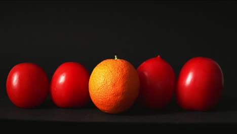 red fresh tomatoes on a black background