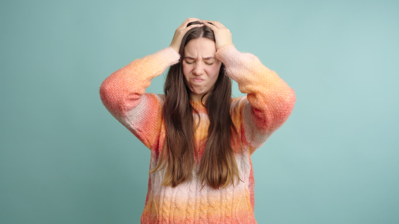 Young female having headache in studio