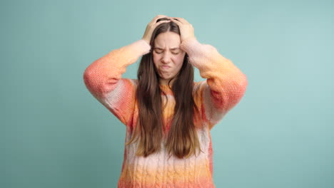 young female having headache in studio