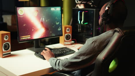 gamer using headphones to discuss with mates while playing sf game, close up