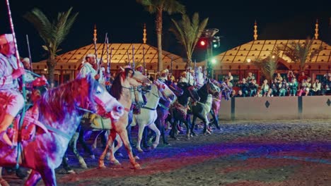 moroccan horsemen in a nighttime spectacle