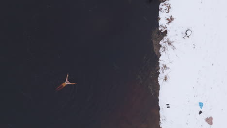 A-woman-swims-in-an-ice-cold-lake-in-Sweden