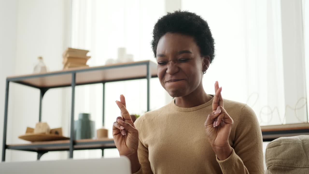 Woman wishing for good luck and celebrating online success