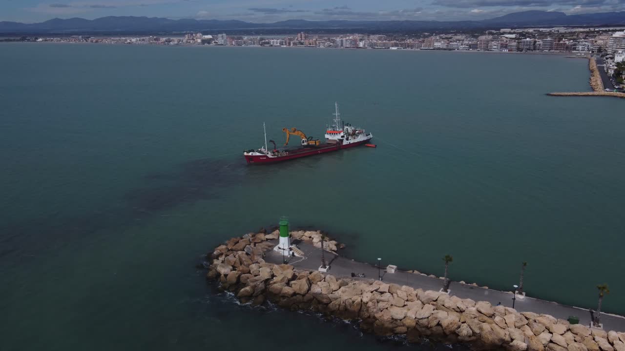 Orbiting around a ship dredging the entrance of a port