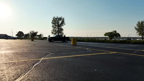 a man walks toward a drone on a summer evening