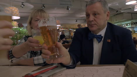 Family-members-toasting-while-having-dinner-in-restaurant